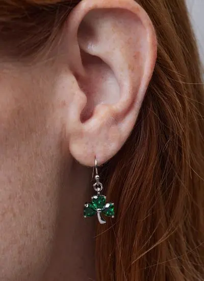 Close up of red haired model wearing Sterling Silver Shamrock Celtic Pendant with Green Cubic Zirconia